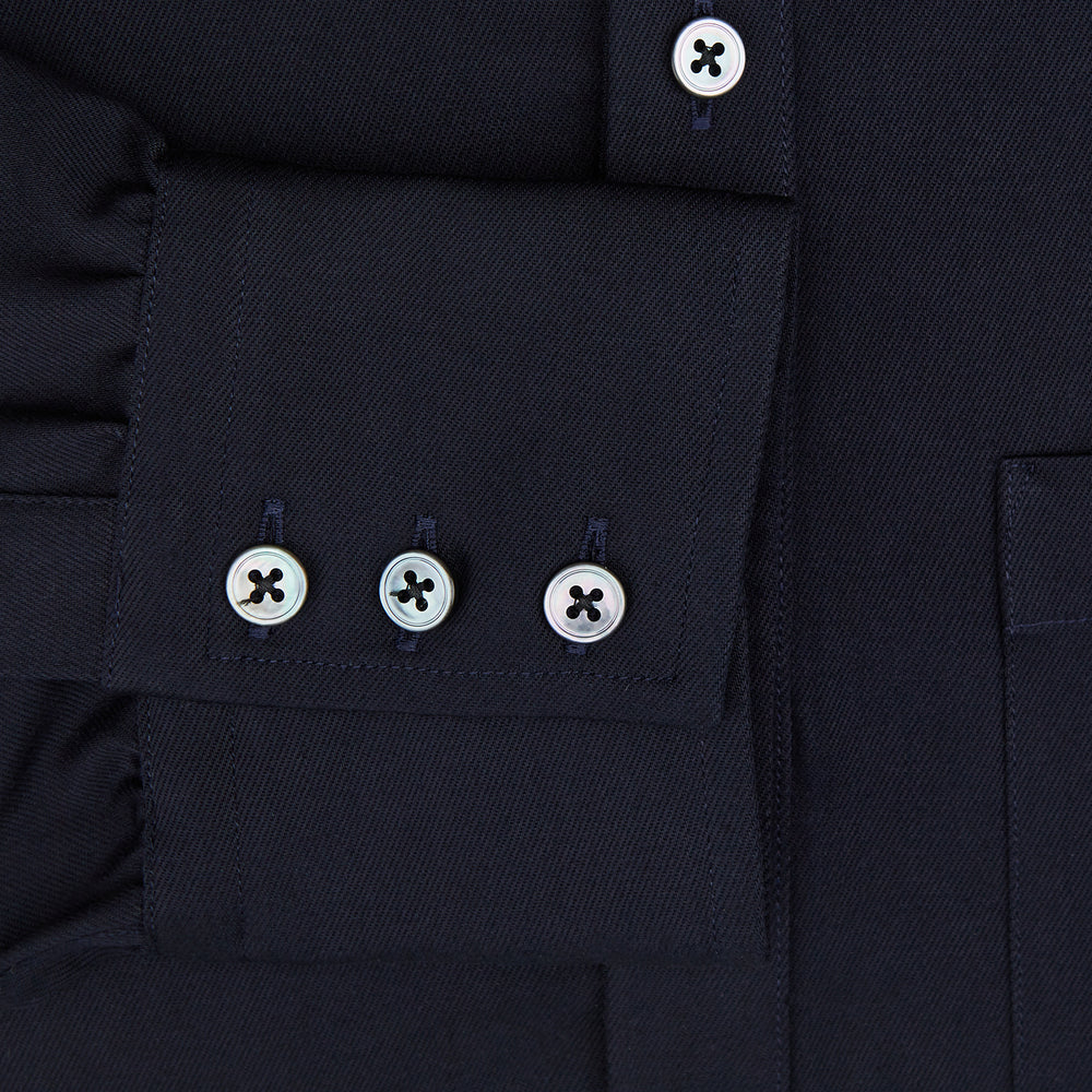 The Turnbull & Asser Navy Twill Chelsea Shirt is a long-sleeve button-up with a collar, front chest pocket, and white buttons, shown against a plain white background.