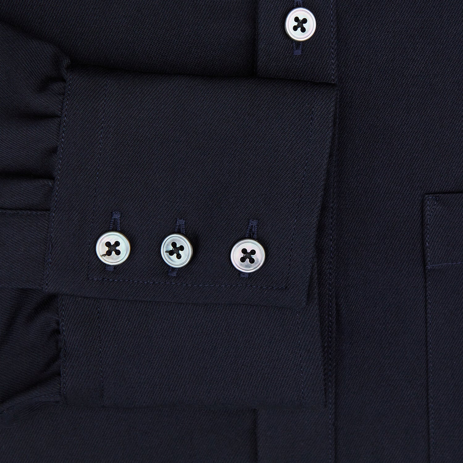 View 4 of product The Turnbull & Asser Navy Twill Chelsea Shirt is a long-sleeve button-up with a collar, front chest pocket, and white buttons, shown against a plain white background.