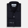 View 5 of product The Turnbull & Asser Navy Twill Chelsea Shirt is a long-sleeve button-up with a collar, front chest pocket, and white buttons, shown against a plain white background.