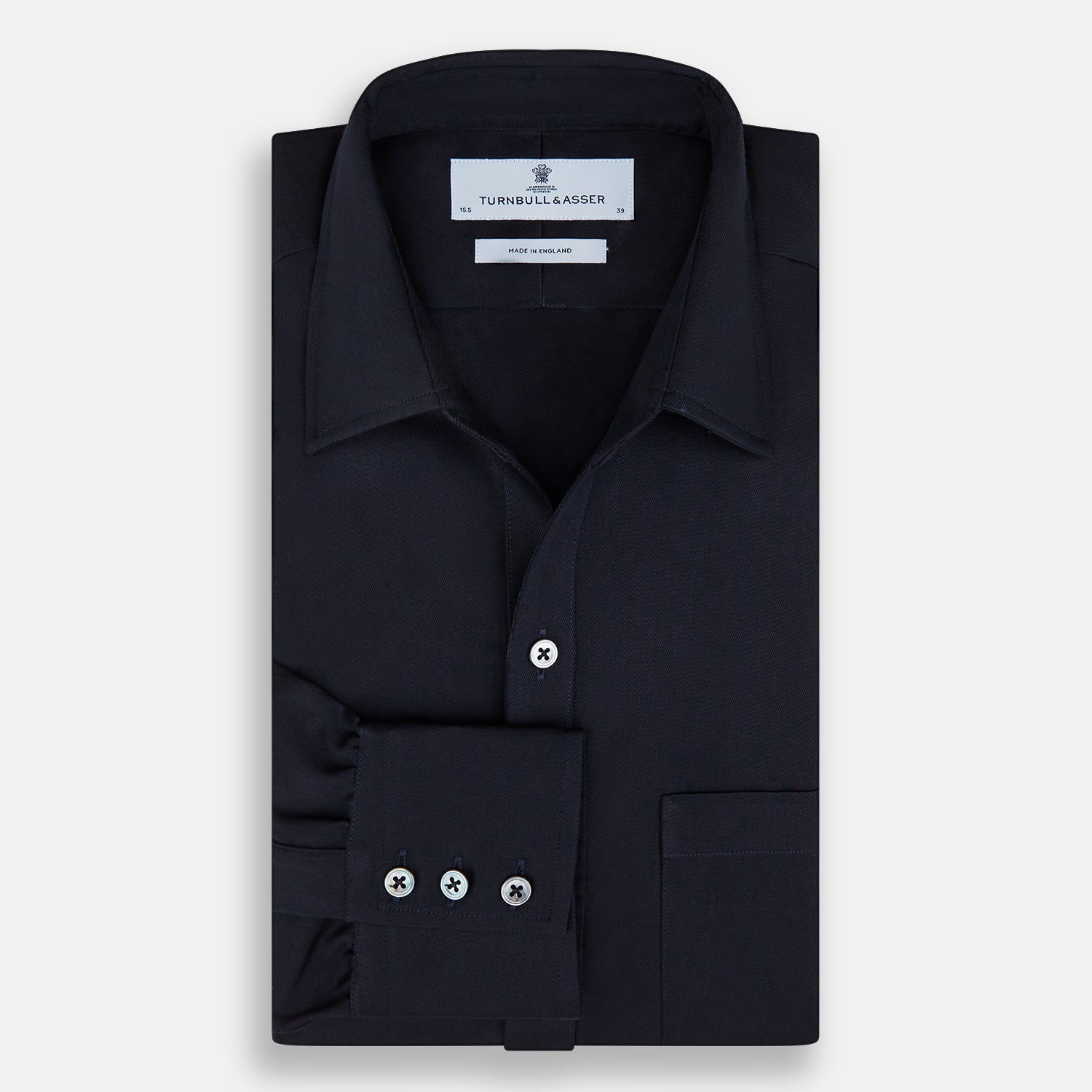 View 5 of product The Turnbull & Asser Navy Twill Chelsea Shirt is a long-sleeve button-up with a collar, front chest pocket, and white buttons, shown against a plain white background.