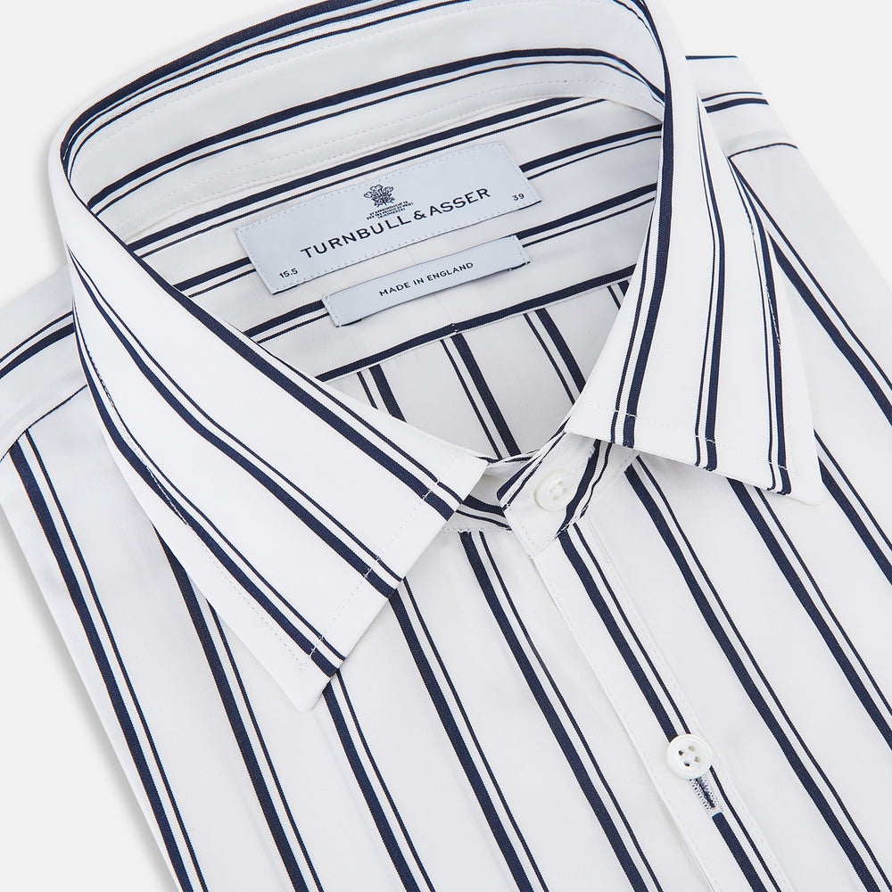 The Turnbull & Asser UK NAVY STRIPED COTTON WESTMINSTER SHIRT features long sleeves, a button-down front, pointed collar, and vertical navy stripes on white for classic British style.
