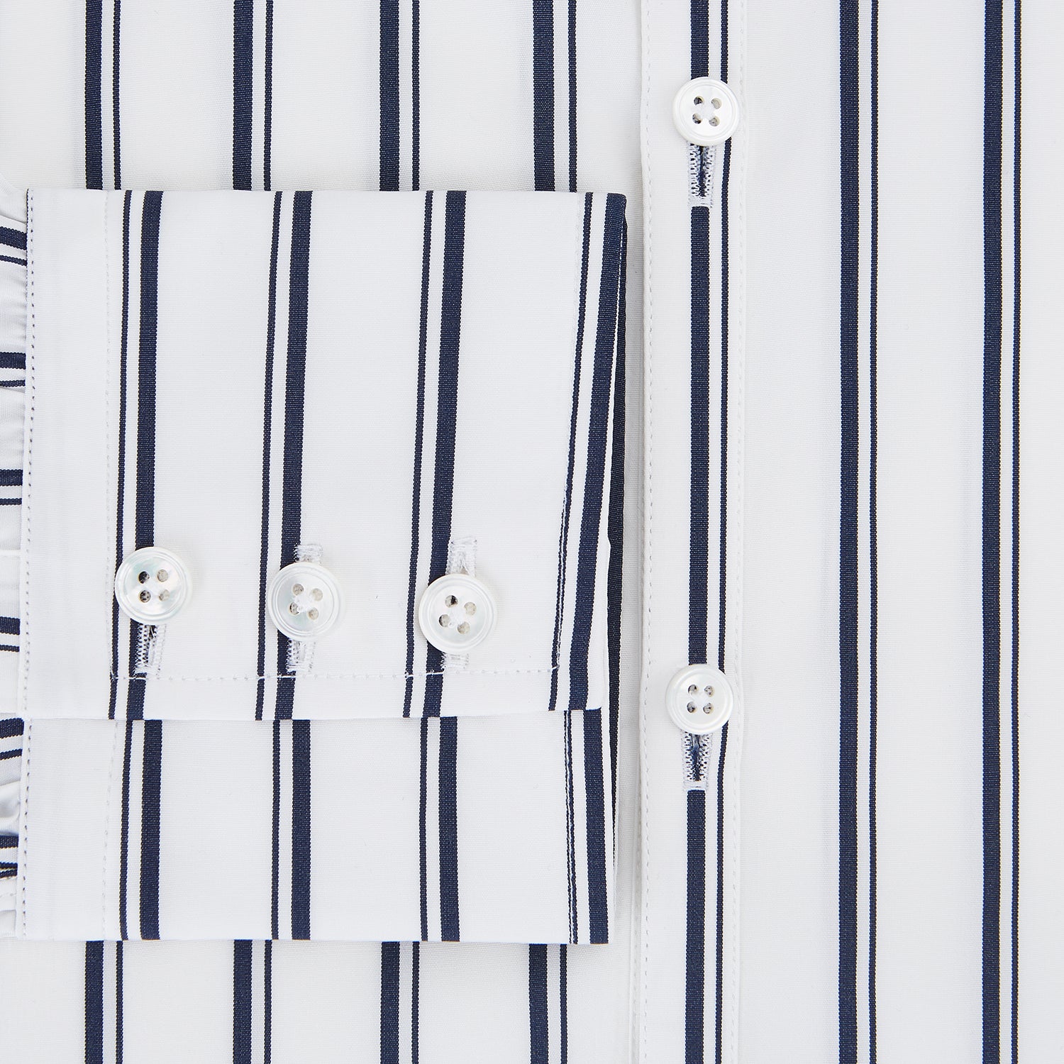 View 4 of product The Turnbull & Asser UK NAVY STRIPED COTTON WESTMINSTER SHIRT features long sleeves, a button-down front, pointed collar, and vertical navy stripes on white for classic British style.