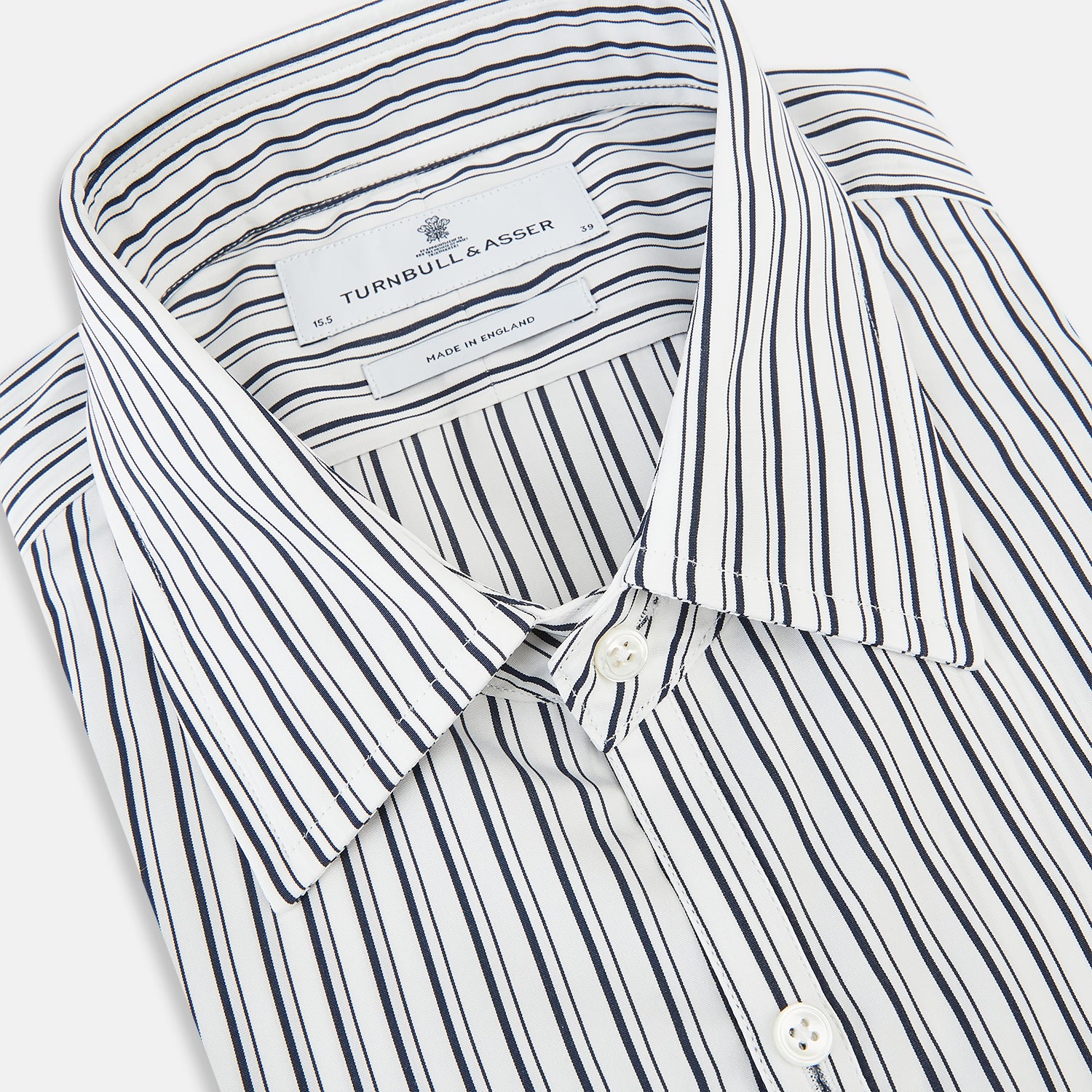View 2 of product Laid flat on a white background, the Turnbull & Asser UK Westminster White Regular Fit Shirt in Cotton features vertical black and white stripes, a classic collar, buttoned cuffs, and a button-up front—an elegant wardrobe essential that offers timeless style for everyday wear.
