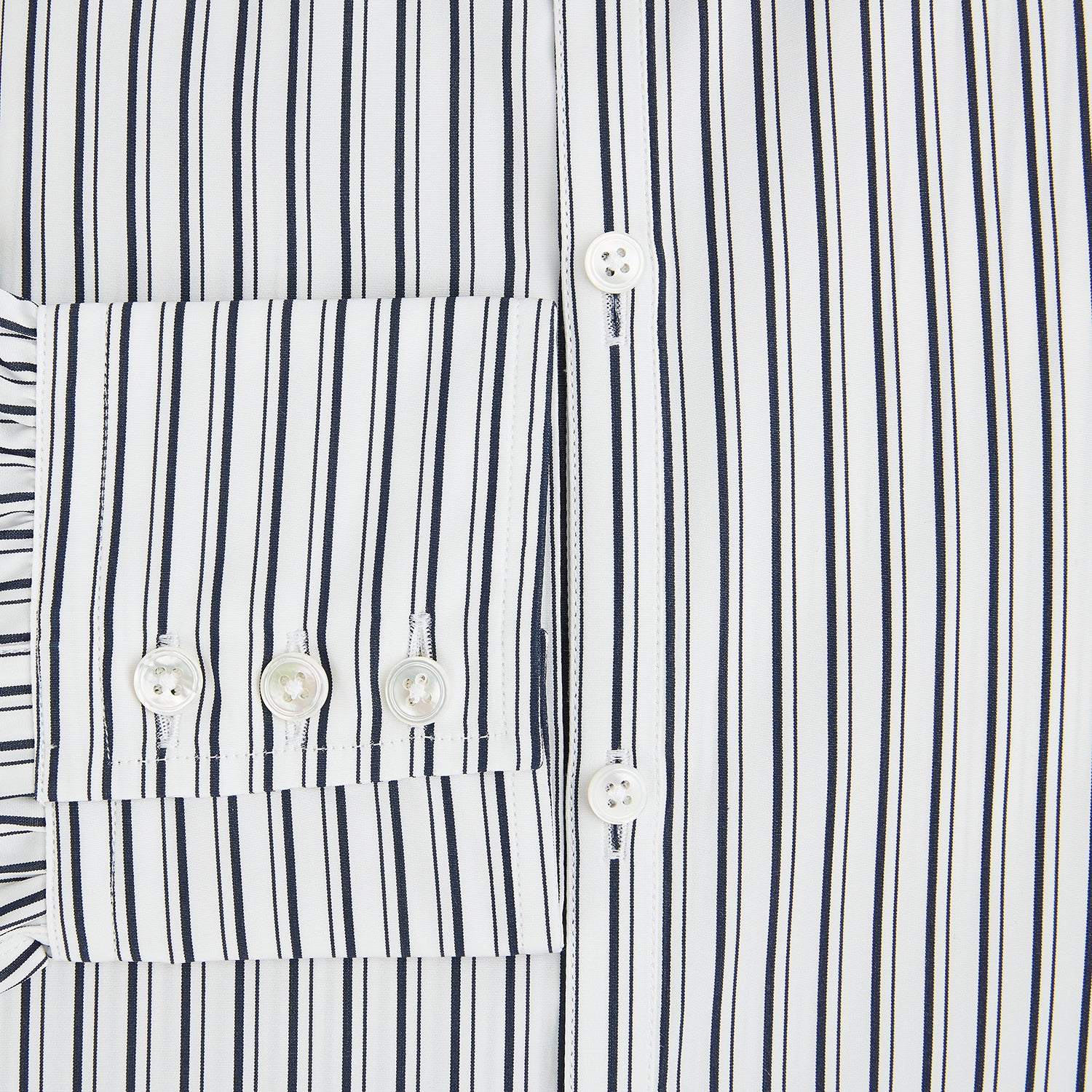 View 4 of product Laid flat on a white background, the Turnbull & Asser UK Westminster White Regular Fit Shirt in Cotton features vertical black and white stripes, a classic collar, buttoned cuffs, and a button-up front—an elegant wardrobe essential that offers timeless style for everyday wear.