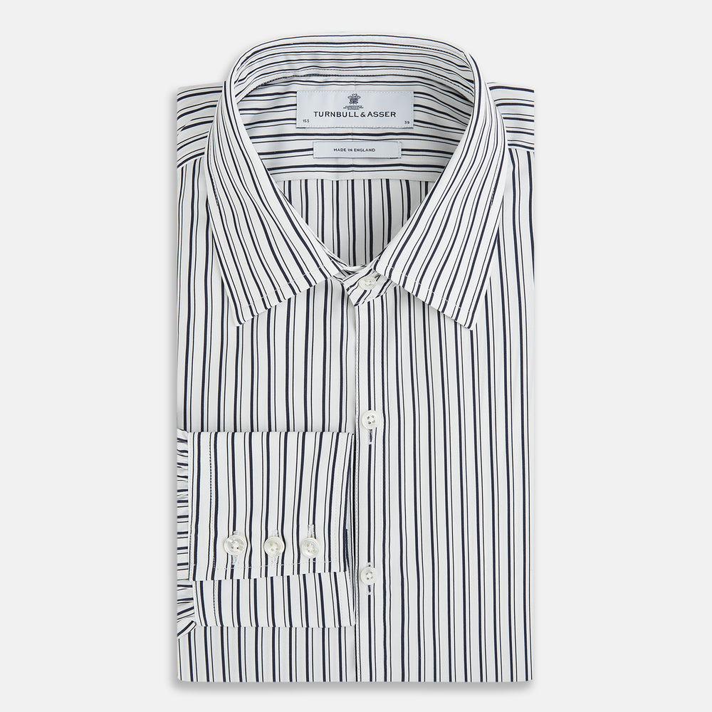 Laid flat on a white background, the Turnbull & Asser UK Westminster White Regular Fit Shirt in Cotton features vertical black and white stripes, a classic collar, buttoned cuffs, and a button-up front—an elegant wardrobe essential that offers timeless style for everyday wear.