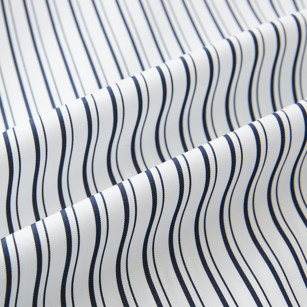 Laid flat on a white background, the Turnbull & Asser UK Westminster White Regular Fit Shirt in Cotton features vertical black and white stripes, a classic collar, buttoned cuffs, and a button-up front—an elegant wardrobe essential that offers timeless style for everyday wear.