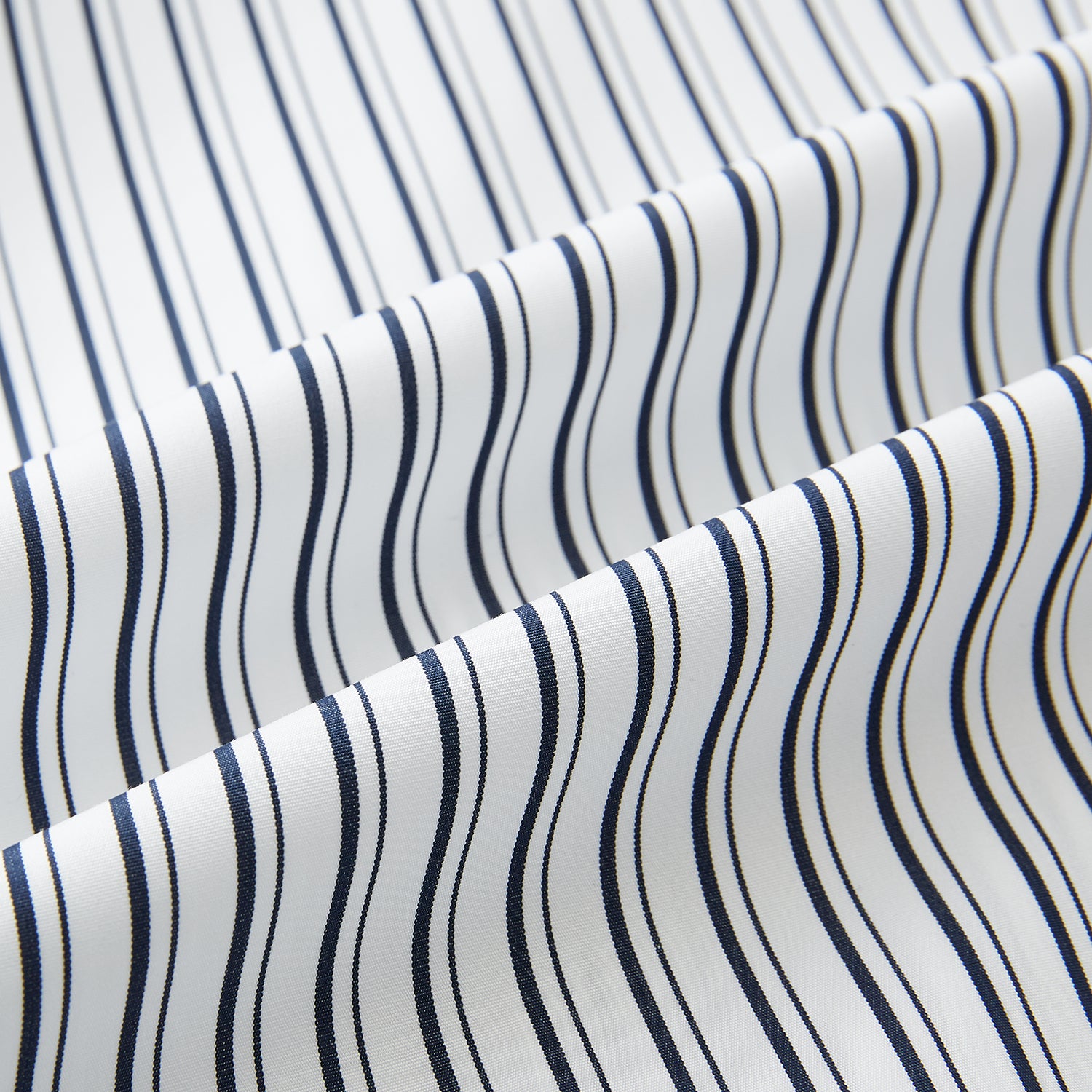 View 8 of product Laid flat on a white background, the Turnbull & Asser UK Westminster White Regular Fit Shirt in Cotton features vertical black and white stripes, a classic collar, buttoned cuffs, and a button-up front—an elegant wardrobe essential that offers timeless style for everyday wear.