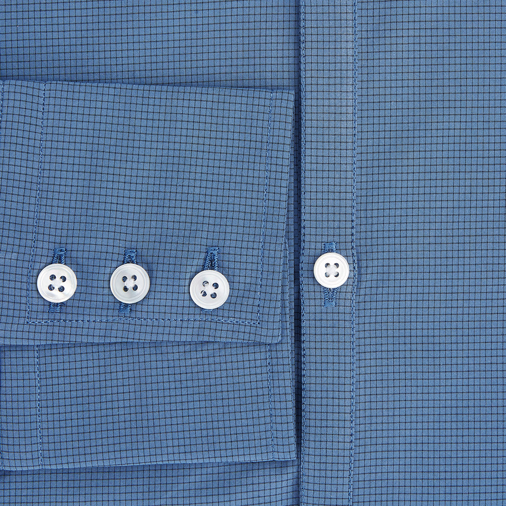 A Colony Blue Pin Check Windsor Shirt by Turnbull & Asser UK, featuring long sleeves, white buttons, a classic Turnbull collar, and buttoned cuffs—expertly crafted in Britain and displayed flat on a white background.