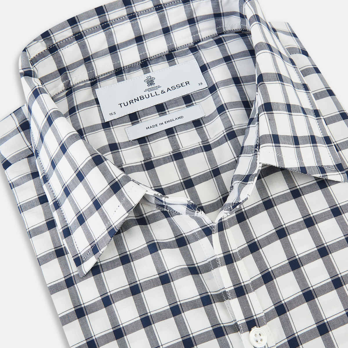 View 2 of product A Chequered Navy on White Windsor Regular Fit Shirt in Cotton by Turnbull & Asser UK, featuring long sleeves, a classic collar, buttoned cuffs, and a navy and white windowpane check pattern, displayed on a white background.