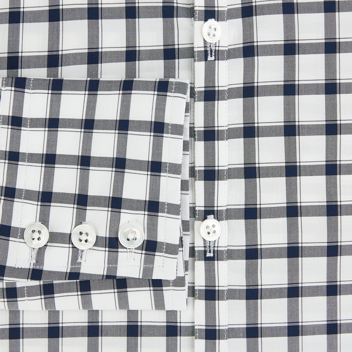 View 3 of product A Chequered Navy on White Windsor Regular Fit Shirt in Cotton by Turnbull & Asser UK, featuring long sleeves, a classic collar, buttoned cuffs, and a navy and white windowpane check pattern, displayed on a white background.