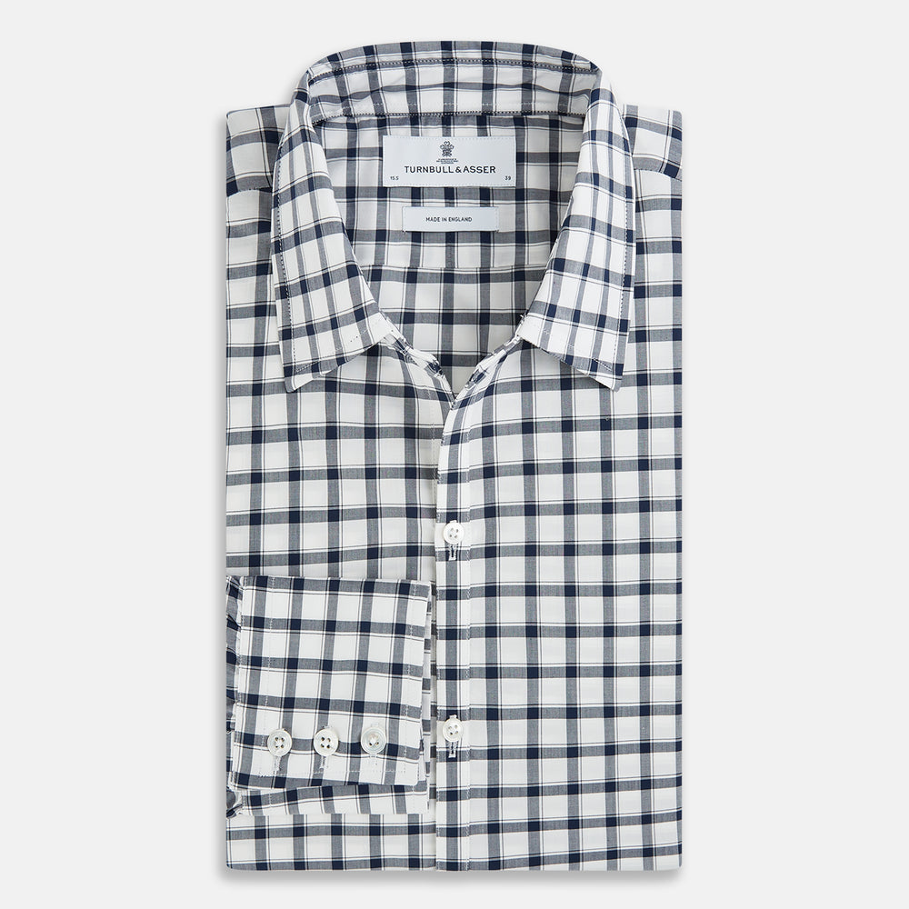 A Chequered Navy on White Windsor Regular Fit Shirt in Cotton by Turnbull & Asser UK, featuring long sleeves, a classic collar, buttoned cuffs, and a navy and white windowpane check pattern, displayed on a white background.