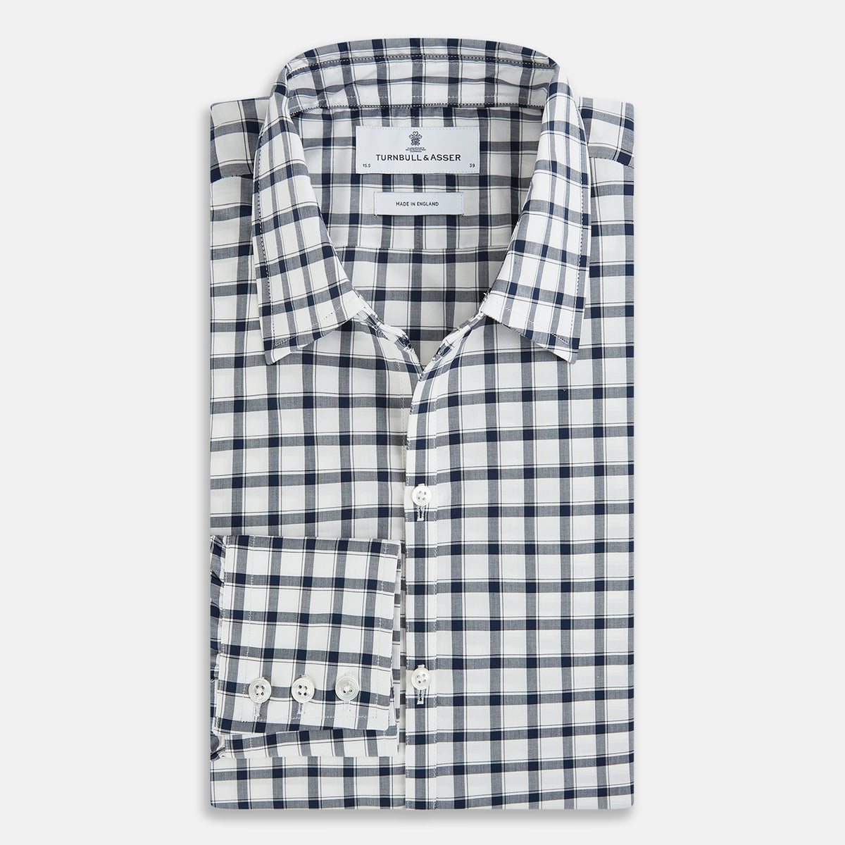 View 4 of product A Chequered Navy on White Windsor Regular Fit Shirt in Cotton by Turnbull & Asser UK, featuring long sleeves, a classic collar, buttoned cuffs, and a navy and white windowpane check pattern, displayed on a white background.