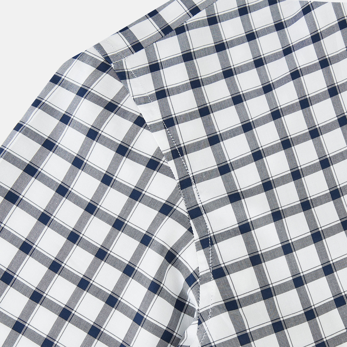 View 5 of product A Chequered Navy on White Windsor Regular Fit Shirt in Cotton by Turnbull & Asser UK, featuring long sleeves, a classic collar, buttoned cuffs, and a navy and white windowpane check pattern, displayed on a white background.