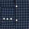 View 4 of product The Turnbull & Asser UK Windsor Navy Regular Fit Shirt in Cotton is a classic men's long-sleeve, button-up shirt featuring a navy blue base with a white grid pattern, displayed laid flat on a white background.