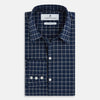 View 5 of product The Turnbull & Asser UK Windsor Navy Regular Fit Shirt in Cotton is a classic men's long-sleeve, button-up shirt featuring a navy blue base with a white grid pattern, displayed laid flat on a white background.