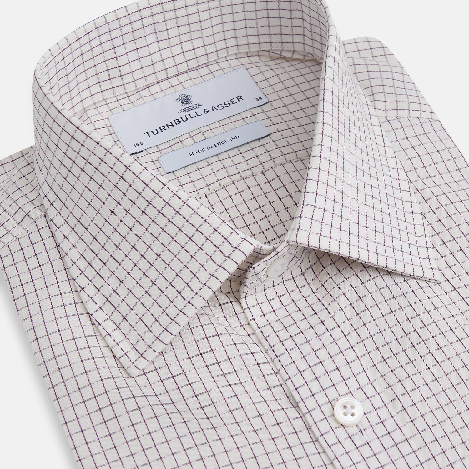 View 2 of product The Turnbull & Asser Purple Graph Check Mayfair Shirt features a classic T&A collar and cuffs, long sleeves, and a subtle purple checkered pattern, shown against a white background.
