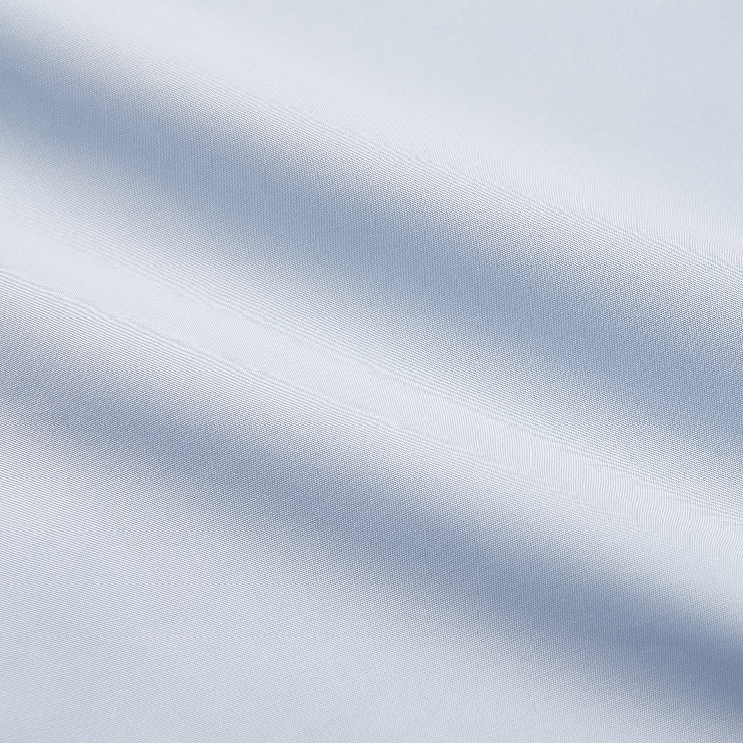 View 5 of product The Turnbull & Asser Tailored Fit Light Blue Cotton Shirt features a Kent collar, buttoned front, and 3-button cuffs, ideal for pairing with a navy suit and shown laid flat on a white background.