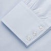 View 4 of product The Turnbull & Asser Tailored Fit Light Blue Cotton Shirt features a Kent collar, buttoned front, and 3-button cuffs, ideal for pairing with a navy suit and shown laid flat on a white background.
