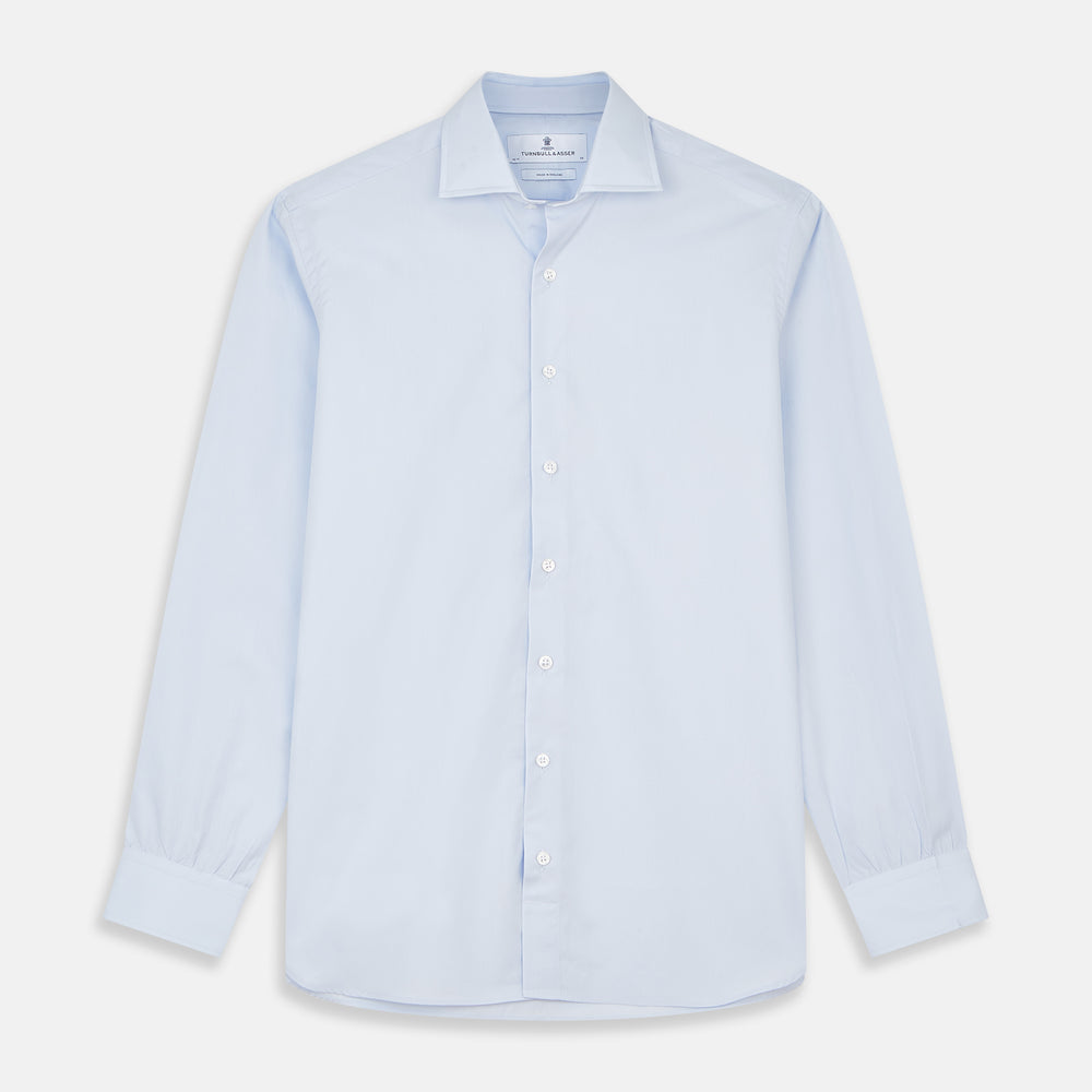 The Turnbull & Asser Tailored Fit Light Blue Cotton Shirt features a Kent collar, buttoned front, and 3-button cuffs, ideal for pairing with a navy suit and shown laid flat on a white background.