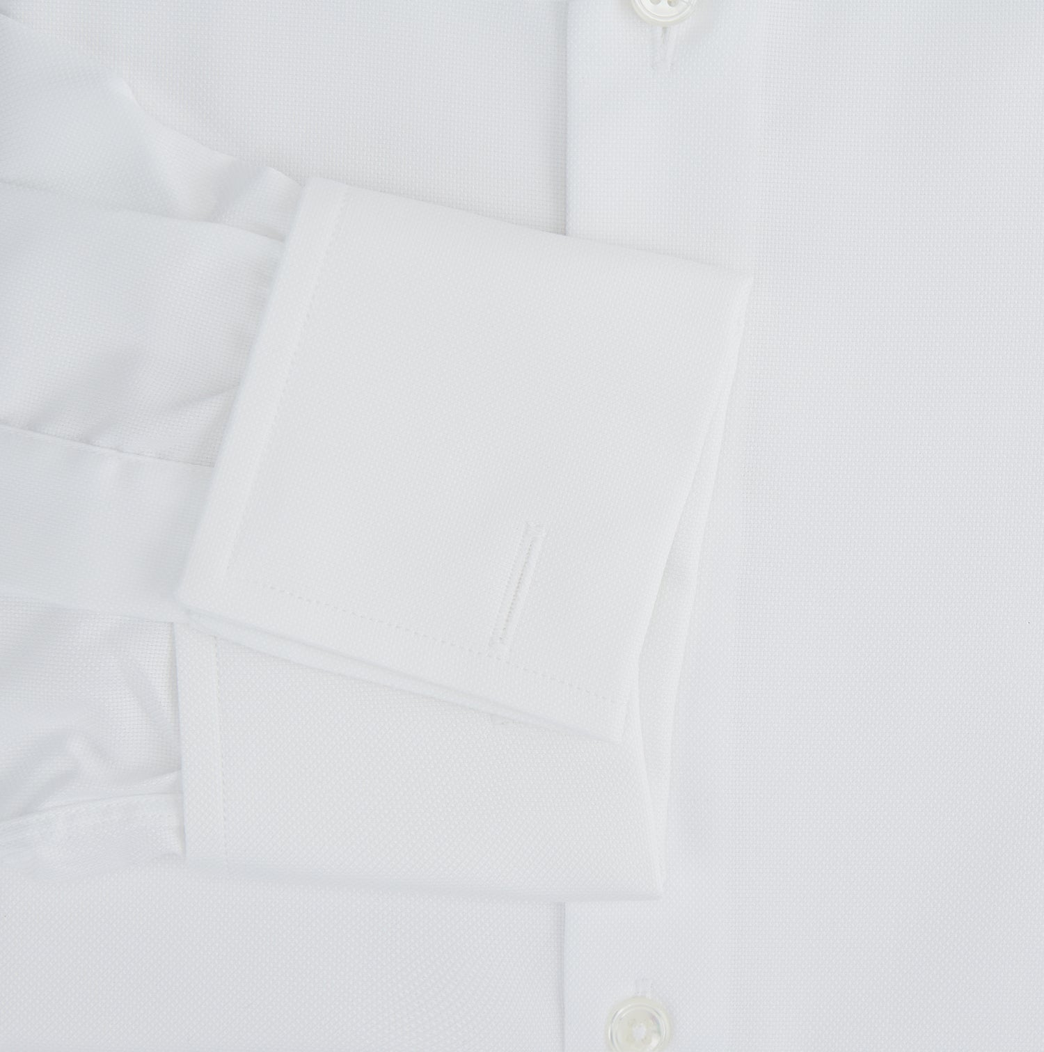 View 4 of product The Turnbull & Asser Tailored Fit White Royal Oxford Cotton Shirt features a Kent collar, double cuffs, and front buttons, shown on a clean white background.