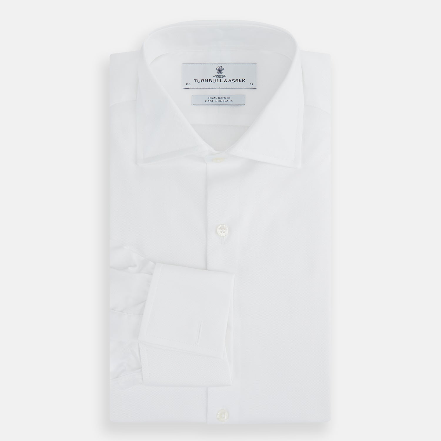 View 5 of product The Turnbull & Asser Tailored Fit White Royal Oxford Cotton Shirt features a Kent collar, double cuffs, and front buttons, shown on a clean white background.