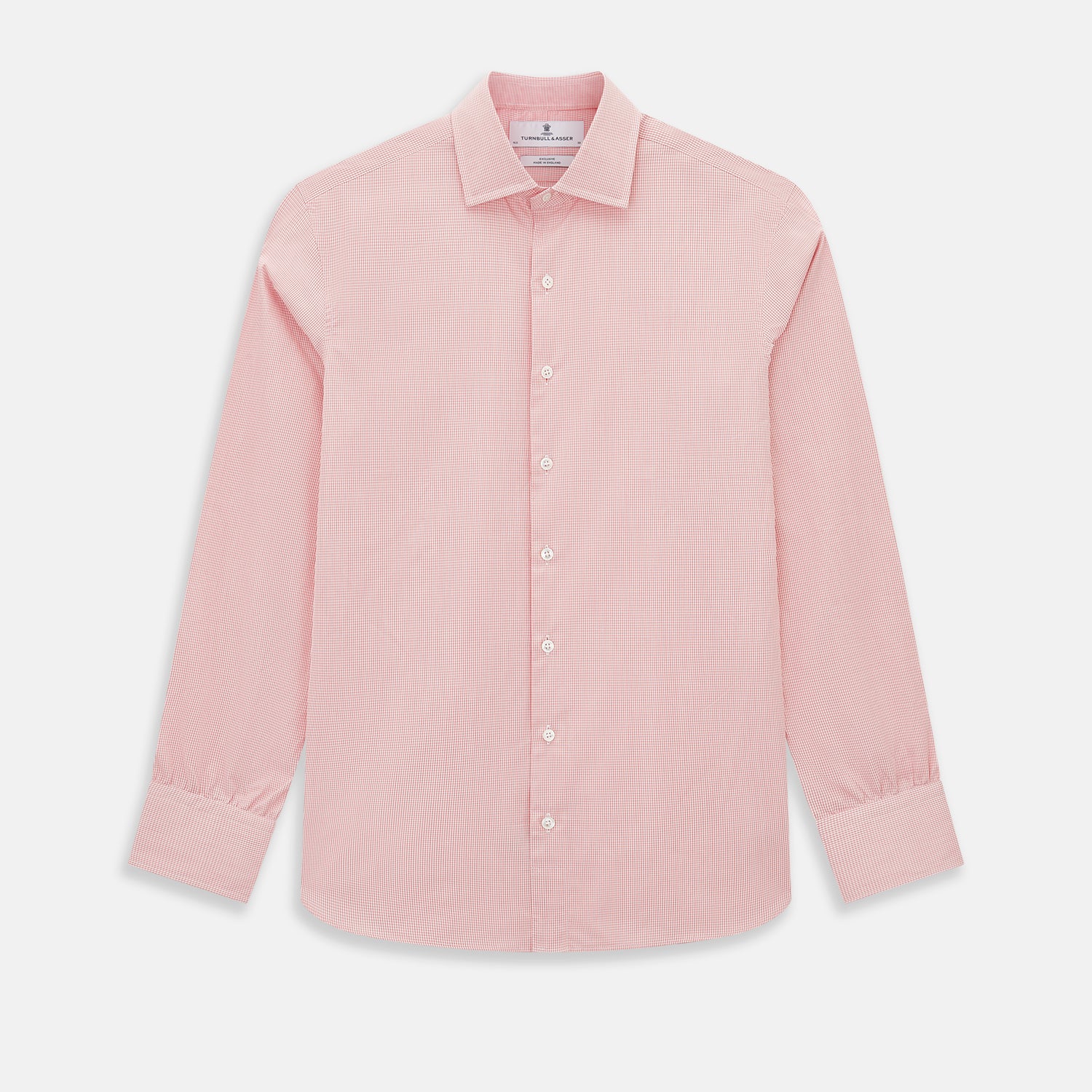 View 1 of product The Turnbull & Asser UK CORAL COTTON MINI CHECKED SHIRT is a light pink long-sleeve button-up shirt with a Kent collar, white buttons, and three-button cuffs, shown on a plain white background.