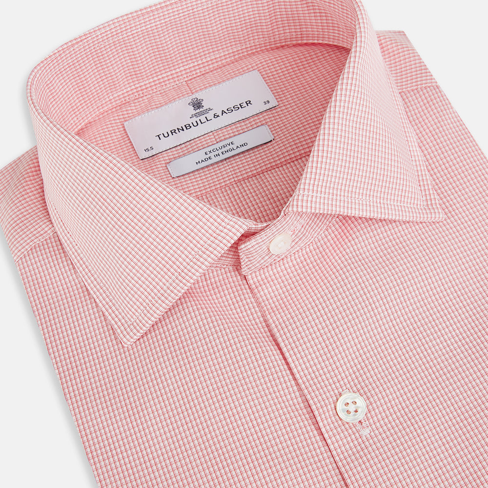 The Turnbull & Asser UK CORAL COTTON MINI CHECKED SHIRT is a light pink long-sleeve button-up shirt with a Kent collar, white buttons, and three-button cuffs, shown on a plain white background.