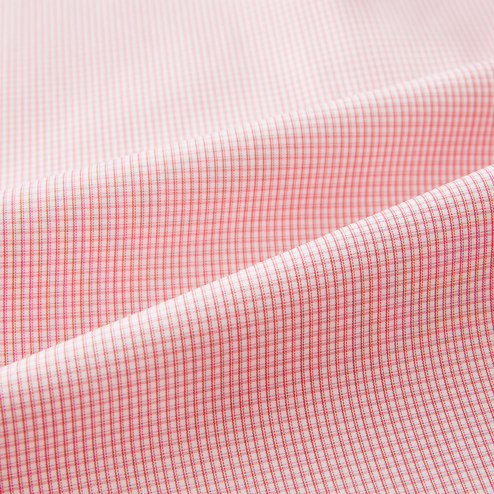 The Turnbull & Asser UK CORAL COTTON MINI CHECKED SHIRT is a light pink long-sleeve button-up shirt with a Kent collar, white buttons, and three-button cuffs, shown on a plain white background.