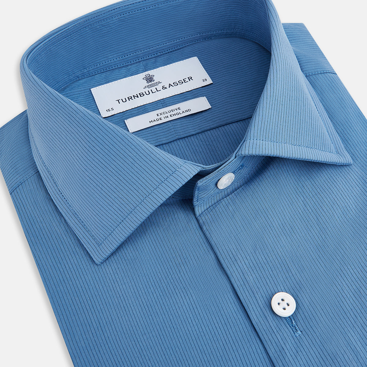 View 2 of product A tailored-fit, long-sleeve Pinstriped Colony Blue Shirt in cotton by Turnbull & Asser UK, featuring a classic collar and white buttons, is displayed on a white background—ideal for formal wear.