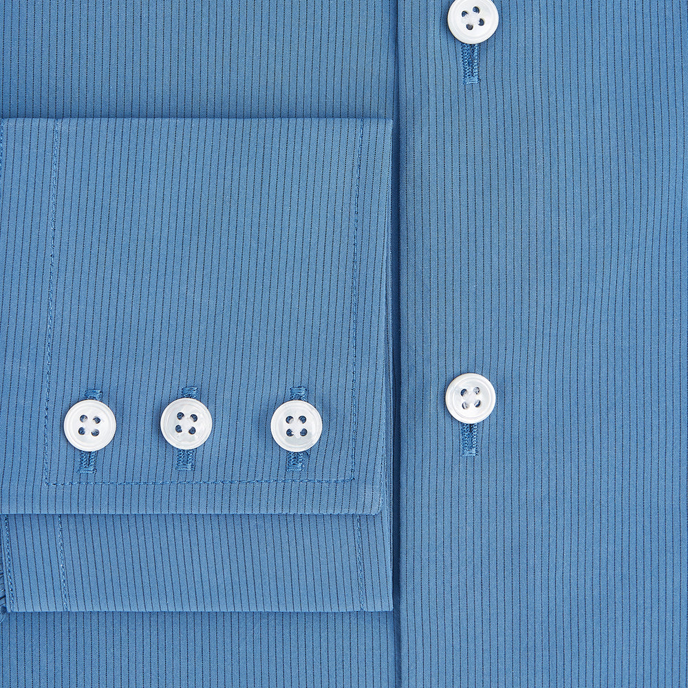 A tailored-fit, long-sleeve Pinstriped Colony Blue Shirt in cotton by Turnbull & Asser UK, featuring a classic collar and white buttons, is displayed on a white background—ideal for formal wear.