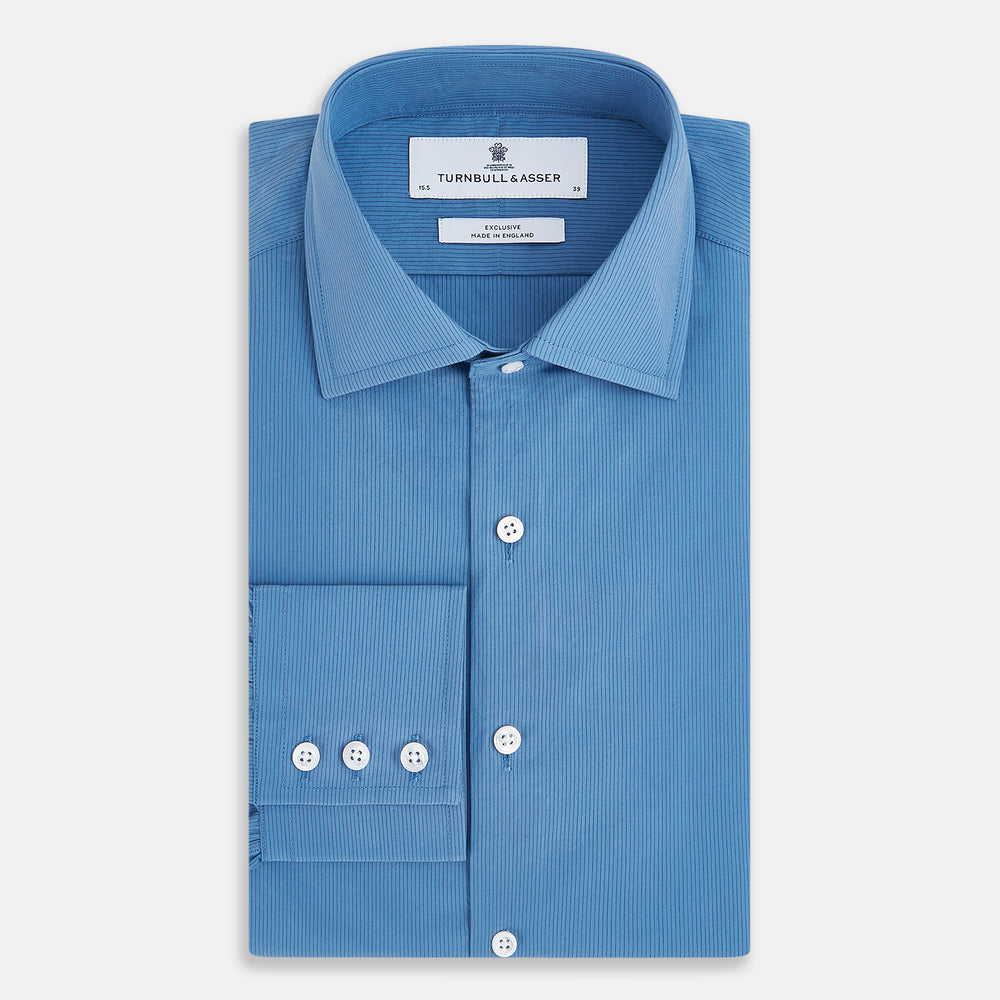 A tailored-fit, long-sleeve Pinstriped Colony Blue Shirt in cotton by Turnbull & Asser UK, featuring a classic collar and white buttons, is displayed on a white background—ideal for formal wear.