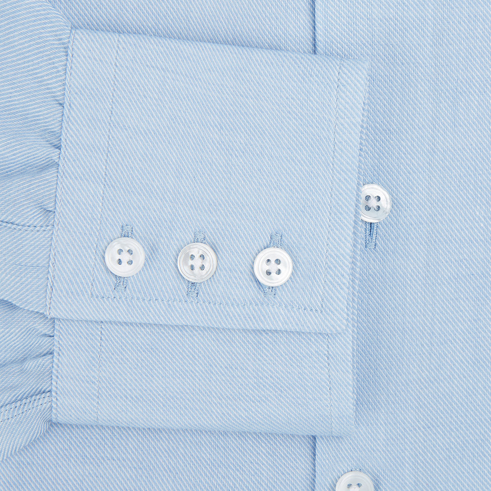 The Turnbull & Asser Tailored Fit Blue Cotton Cashmere Belgravia Shirt features a classic collar, button-down front, and buttoned cuffs, shown laid flat on a white background for a refined, formal look.