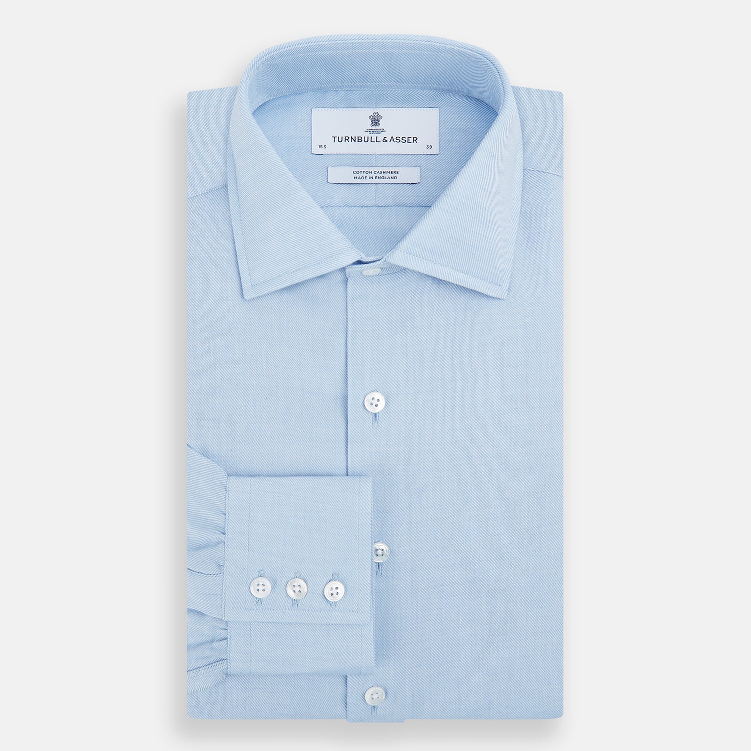 View 5 of product The Turnbull & Asser Tailored Fit Blue Cotton Cashmere Belgravia Shirt features a classic collar, button-down front, and buttoned cuffs, shown laid flat on a white background for a refined, formal look.