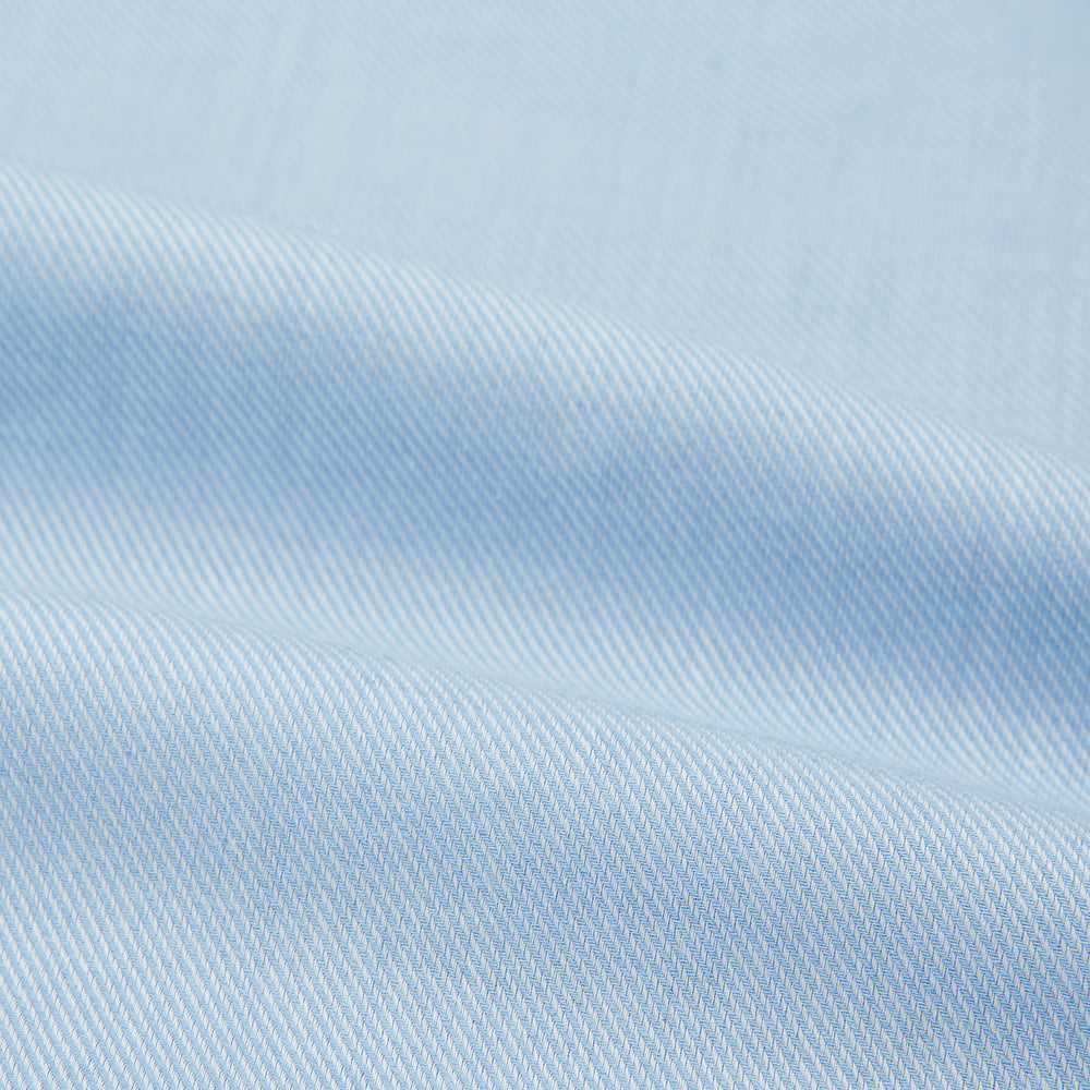 The Turnbull & Asser Tailored Fit Blue Cotton Cashmere Belgravia Shirt features a classic collar, button-down front, and buttoned cuffs, shown laid flat on a white background for a refined, formal look.