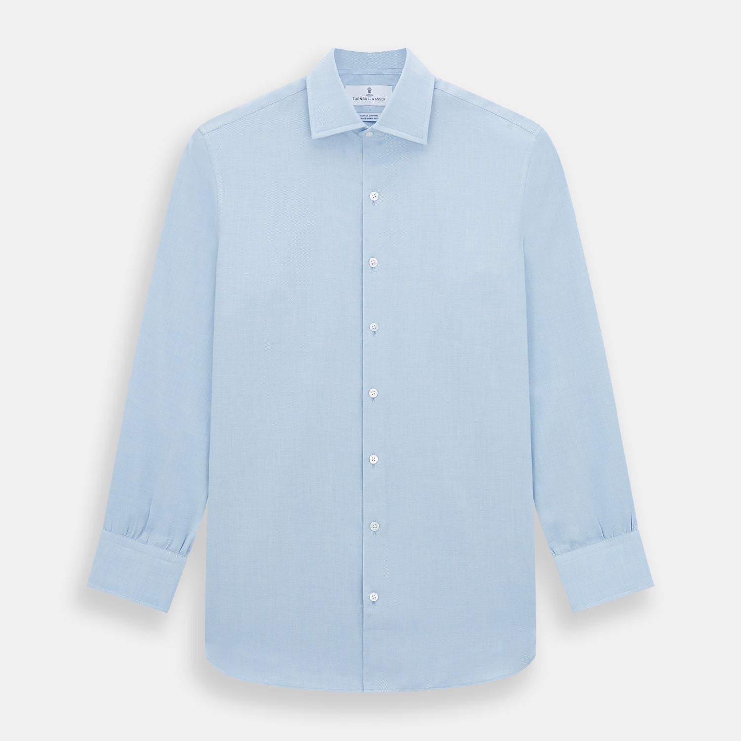 View 1 of product The Turnbull & Asser Tailored Fit Blue Cotton Cashmere Belgravia Shirt features a classic collar, button-down front, and buttoned cuffs, shown laid flat on a white background for a refined, formal look.