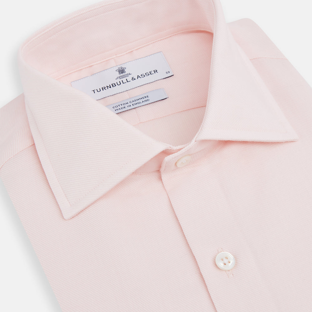 The Turnbull & Asser Tailored Fit Pale Pink Cotton Cashmere Belgravia Shirt features long sleeves and a collar for a formal look, shown flat against a white background.