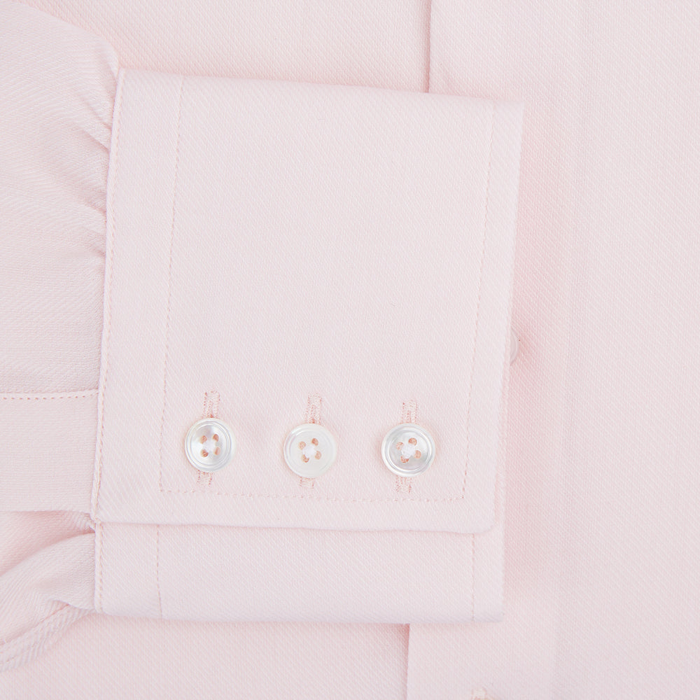 The Turnbull & Asser Tailored Fit Pale Pink Cotton Cashmere Belgravia Shirt features long sleeves and a collar for a formal look, shown flat against a white background.