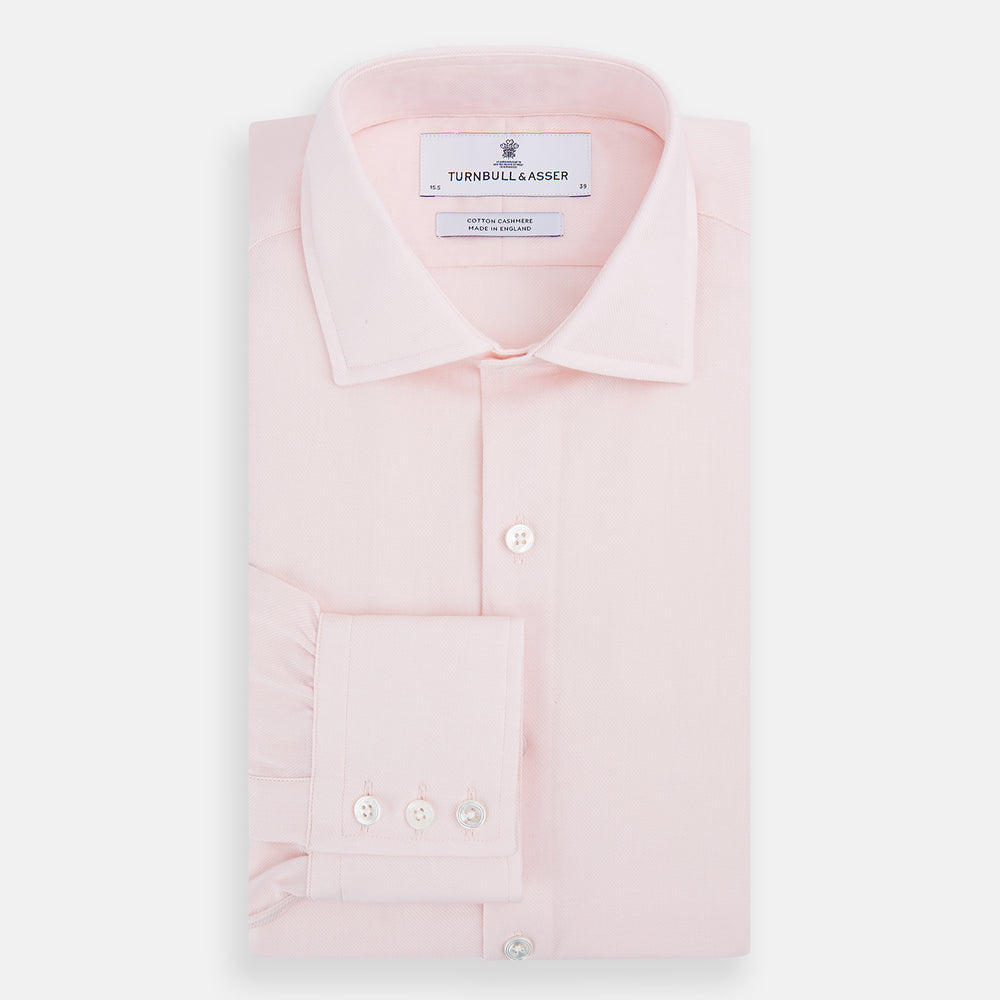The Turnbull & Asser Tailored Fit Pale Pink Cotton Cashmere Belgravia Shirt features long sleeves and a collar for a formal look, shown flat against a white background.