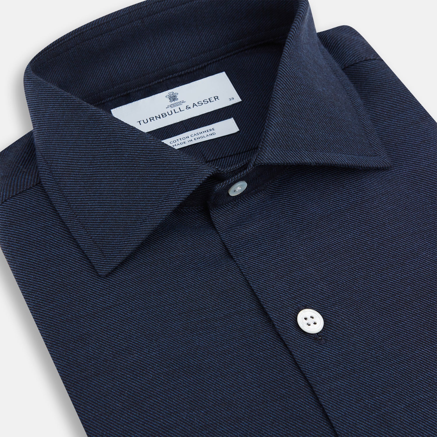 View 2 of product The Turnbull & Asser Tailored Fit Navy Cotton Cashmere Belgravia Shirt features a classic collar, white buttons, and long sleeves, shown on a white background.