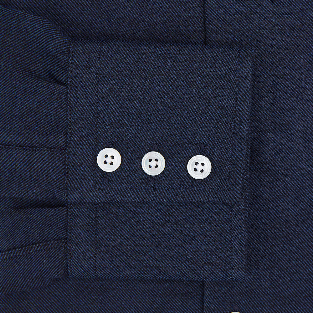 The Turnbull & Asser Tailored Fit Navy Cotton Cashmere Belgravia Shirt features a classic collar, white buttons, and long sleeves, shown on a white background.