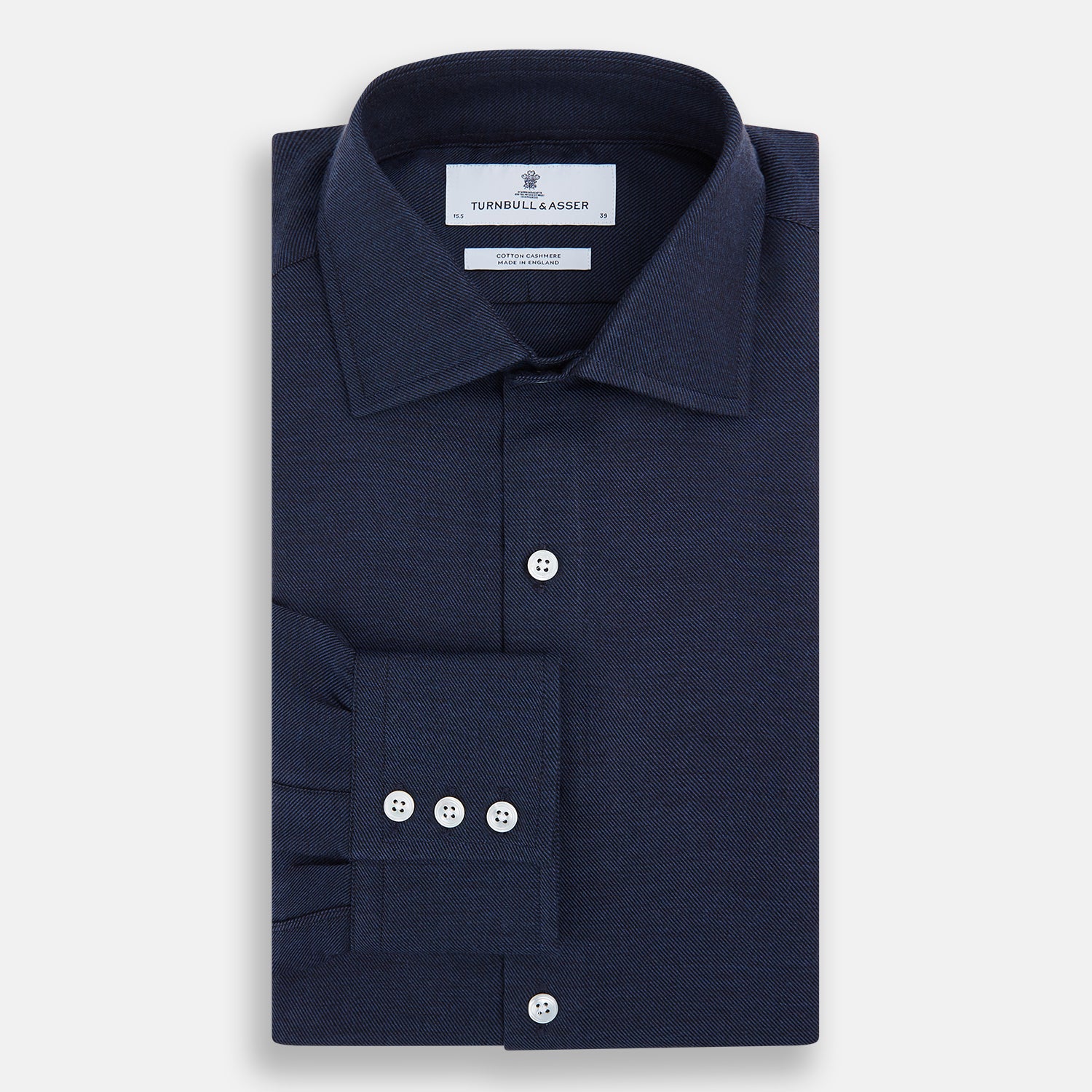 View 5 of product The Turnbull & Asser Tailored Fit Navy Cotton Cashmere Belgravia Shirt features a classic collar, white buttons, and long sleeves, shown on a white background.