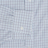 View 3 of product The Turnbull & Asser Blue Double Graph Check Richmond Shirt features a light blue and white check pattern, front pocket, Derby collar, buttoned cuffs, and long sleeves, shown laid flat on a white background.