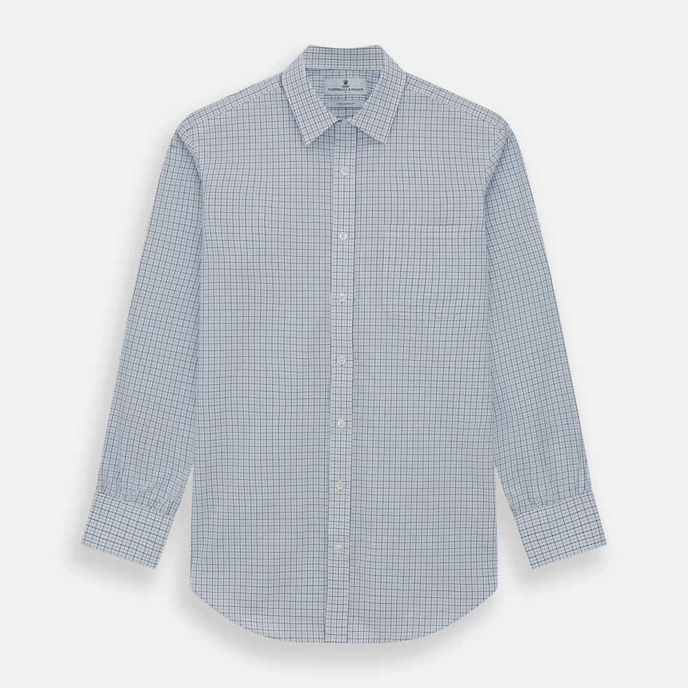 The Turnbull & Asser Blue Double Graph Check Richmond Shirt features a light blue and white check pattern, front pocket, Derby collar, buttoned cuffs, and long sleeves, shown laid flat on a white background.