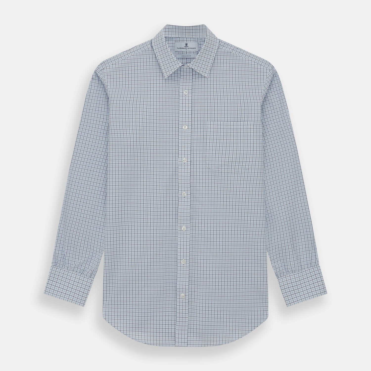 View 1 of product The Turnbull & Asser Blue Double Graph Check Richmond Shirt features a light blue and white check pattern, front pocket, Derby collar, buttoned cuffs, and long sleeves, shown laid flat on a white background.