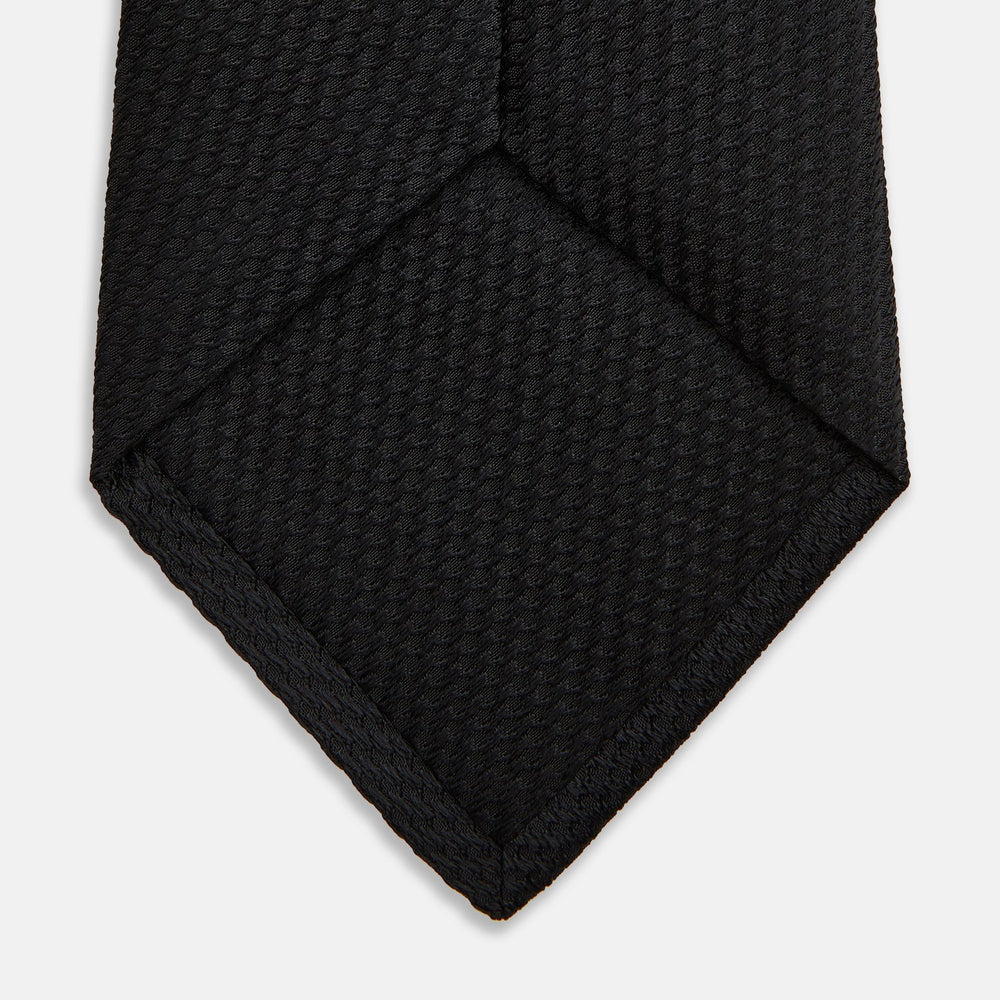 The Turnbull & Asser Black Lace Silk Tie, featuring a refined texture, is elegantly displayed on a white background.
