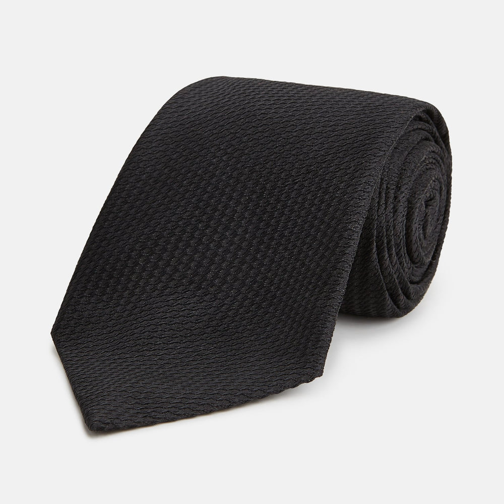 The Turnbull & Asser Black Lace Silk Tie, featuring a refined texture, is elegantly displayed on a white background.