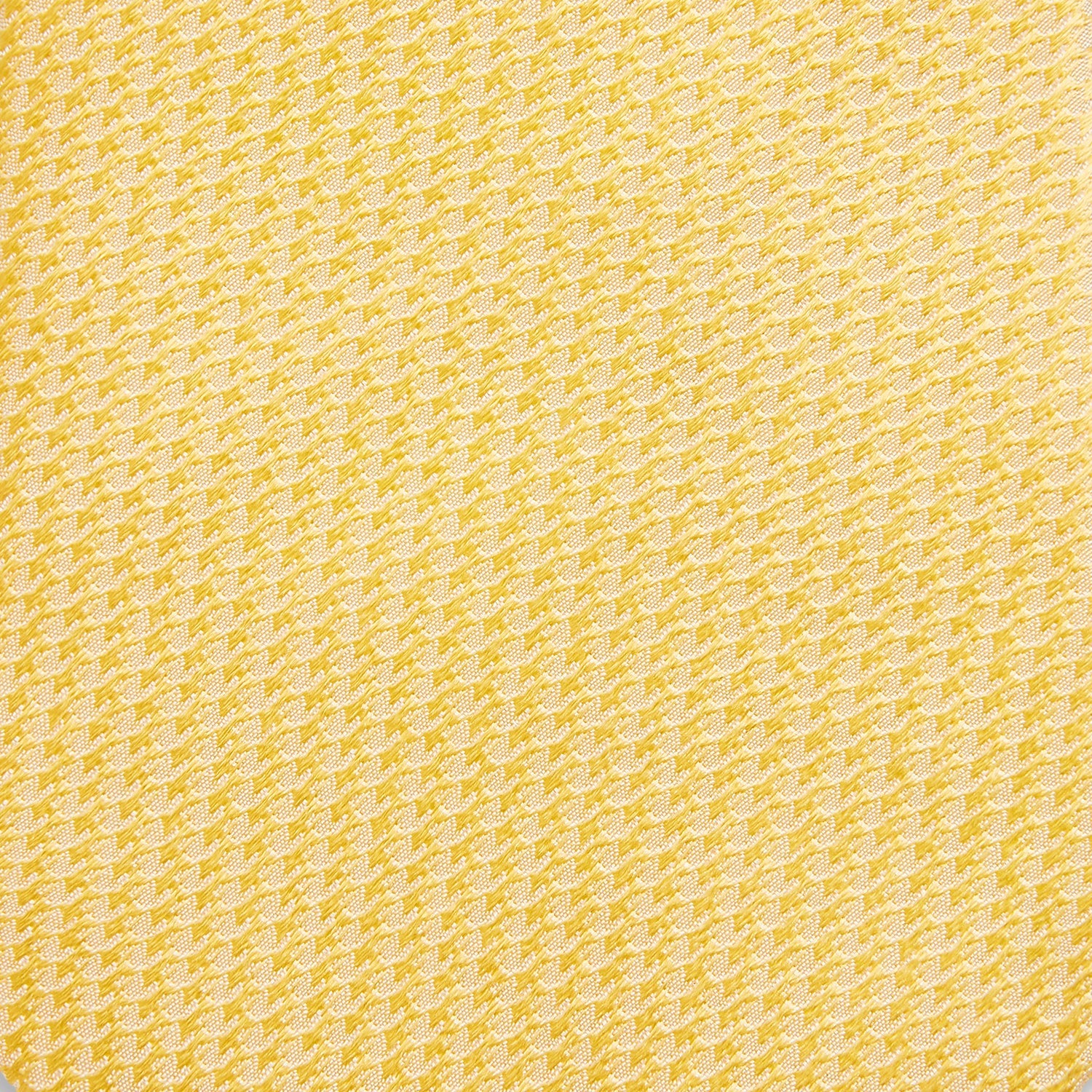 View 3 of product The Turnbull & Asser Yellow Lace Silk Tie, featuring a light yellow hue and subtle texture, is neatly rolled and displayed on a plain white background.