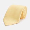 View 1 of product The Turnbull & Asser Yellow Lace Silk Tie, featuring a light yellow hue and subtle texture, is neatly rolled and displayed on a plain white background.