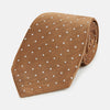 View 1 of product The Turnbull & Asser Camel and White Small Spot Herringbone Silk Tie features a stylish herringbone pattern with white spots—an elegant accessory ideal for modern office attire.