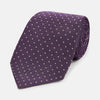View 1 of product The Turnbull & Asser Lilac and Purple Micro Dot Silk Tie, featuring a subtle white micro-dot pattern, is rolled up and displayed on a white background—an essential addition to any polished wardrobe.